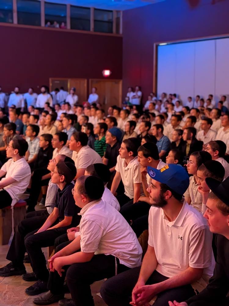 Rows of men watching a show